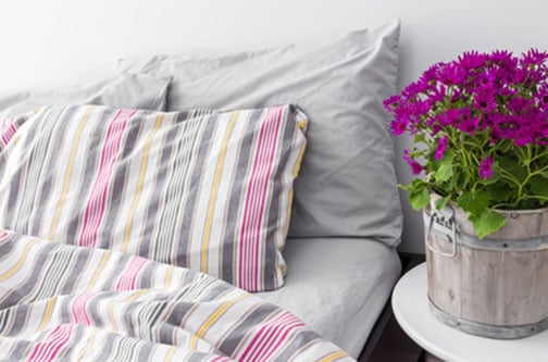 Make your homecare bedroom settings look as natural as possible. Add a comforter and pillows, so customers can envision their rest.