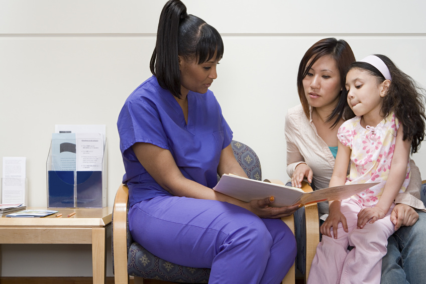Pediatric Nurse talking to mother and daughter about care regimen