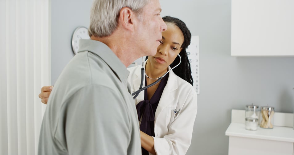 woman doctor listening to senior breathing