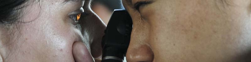 doctor looking at patient's eye