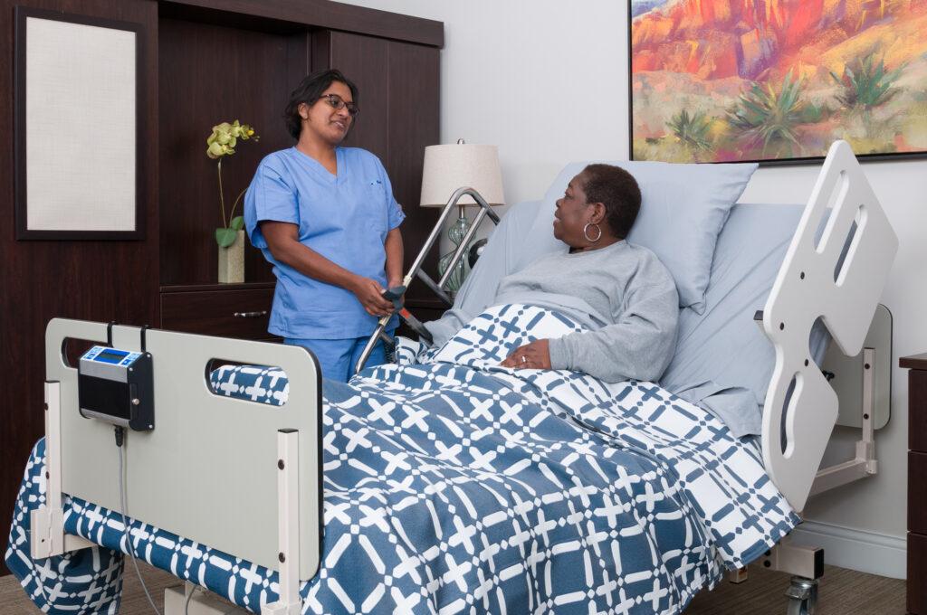 Patient in hospital bed and caregiver